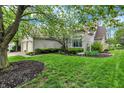 Attractive brick home with attached garage, beautiful landscaping, and a well-maintained lawn at 7110 Koldyke Dr, Fishers, IN 46038