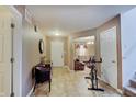 Home entryway featuring tile floors, access to the living room, and staircase to the upper level at 7303 Beal Ln, Indianapolis, IN 46217