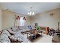 The room features neutral-toned walls, carpet flooring, and a large sectional sofa at 7303 Beal Ln, Indianapolis, IN 46217