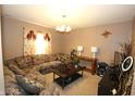 Cozy living room featuring a large floral sofa, coffee table, and decorative accents at 7303 Beal Ln, Indianapolis, IN 46217