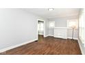 Bright living room with wood floors and a white brick fireplace, offering a welcoming space with ample natural light at 736 N Dequincy St, Indianapolis, IN 46201
