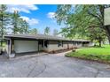 Welcoming home with a two-car garage, charming landscaping, and inviting walkway at 7425 E Thompson Rd, Indianapolis, IN 46239