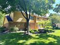 Back of home with brick and vinyl siding with large windows and a spacious yard at 7621 Forest Dr, Fishers, IN 46038