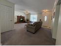 Spacious living room showcasing a cozy fireplace, plush carpeting, and neutral wall color at 8310 Goat Hollow Rd, Martinsville, IN 46151