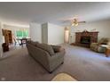 Inviting living room featuring a brick fireplace, plush carpeting, and a comfortable sofa at 8310 Goat Hollow Rd, Martinsville, IN 46151