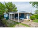 Attractive one-story house with blue siding, brick elements, a carport, and well-maintained landscaping at 8814 W 30Th St, Indianapolis, IN 46234
