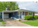Charming one-story house showcasing blue siding, brick accents, and a convenient covered carport at 8814 W 30Th St, Indianapolis, IN 46234