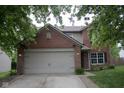 Charming two-story brick home with a well-maintained lawn and attached two-car garage at 8912 Hosta Way, Indianapolis, IN 46113