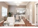 Open-concept living space with stylish dining area and hardwood floors, leading to the modern kitchen at 940 E Pleasant Run Parkway North Dr, Indianapolis, IN 46203