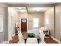 Inviting open-concept living space with a dark wood front door, hardwood floors, and neutral decor at 940 E Pleasant Run Parkway North Dr, Indianapolis, IN 46203