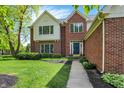 Attractive brick home with a well-kept lawn, garden beds, and a welcoming front entrance at 9583 Greenthread Dr, Zionsville, IN 46077