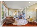 Cozy living room with large windows, stylish decor, and custom built-in bookshelves at 9749 Soaring Eagle Ln, Fishers, IN 46055