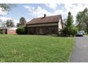 Charming brick home with a well-manicured lawn and inviting front entrance at 9903 E Raymond St, Indianapolis, IN 46239