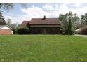 Charming brick home with a well-manicured lawn and inviting front entrance at 9903 E Raymond St, Indianapolis, IN 46239