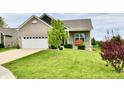 Lovely house with a large front yard, two-car garage, and inviting porch with bench seating at 998 Cass Dr, Franklin, IN 46131