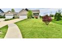 Beautiful home featuring a well-maintained lawn and a two-car garage, surrounded by lush greenery at 998 Cass Dr, Franklin, IN 46131
