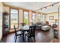 Sunlit living area with hardwood floors, large windows, and stylish furniture at 1026 Jackson St, Columbus, IN 47201
