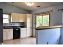 An incomplete kitchen featuring cream cabinets, black appliances and sliding glass doors to the backyard at 107 Camelia Ct, Mooresville, IN 46158