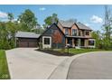 Expansive driveway leading to a stylish home with a three-car garage and well-maintained landscaping at 11064 Hamilton Run, Zionsville, IN 46077