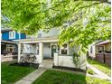 Quaint two-story home with a cozy front porch and well-kept landscaping, perfect for families at 1205 N Oxford St, Indianapolis, IN 46201