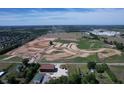 Expansive aerial view showcases new construction development with a mix of open land and industrial buildings at 12613 Morning Ridge Way, Noblesville, IN 46060