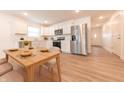 Bright eat-in kitchen featuring stainless steel appliances, sleek white cabinetry, and a dining table at 1491 Coen Ct, Columbus, IN 47201