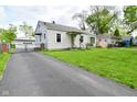 Single-story home with a driveway and fenced-in yard at 1507 N Luett Ave, Indianapolis, IN 46222