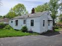 View of the home's exterior and backyard with ample parking on a paved driveway at 1507 N Luett Ave, Indianapolis, IN 46222