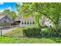 Charming single-story home with fenced-in yard and quaint sunroom at 1523 E Perry St, Indianapolis, IN 46227