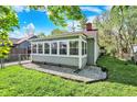 The sunroom offers lots of natural light with windows surrounding three sides of the room at 1523 E Perry St, Indianapolis, IN 46227