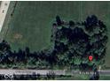 Aerial view of property featuring a treed lot on a rural road at 15490 W 700 S, Anderson, IN 46017