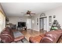 Inviting living room with wood flooring, a ceiling fan, and comfortable seating in a cozy setting at 1683 W County Road 300 S, Danville, IN 46122