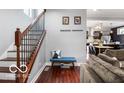 Home entryway with wooden floors, bench seating, and staircase leading upstairs at 1808 E 11Th St, Indianapolis, IN 46201