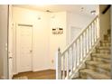Hallway features stairs, white trim, wood floors, and doors leading to other rooms at 1831 Brook Crossing Way, Indianapolis, IN 46229