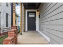 Close-up of the front entrance with black door and brick accents at 202 Mckim Ave, Indianapolis, IN 46201