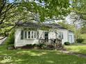 Charming single-story home with a cozy front porch and bay window at 212 Vasbinder Dr, Chesterfield, IN 46017
