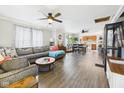 Open-concept living area with hardwood floors, ceiling fans, and seamless flow to the dining and kitchen spaces at 2314 Walnut St, Anderson, IN 46016