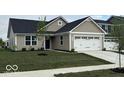 Charming single-story home featuring a two-car garage, a blue door, and a well-manicured front lawn at 2334 Black Rock Cir, Lebanon, IN 46052