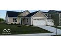 Charming single-story home featuring a two-car garage, a blue door, and a well-manicured front lawn at 2334 Black Rock Cir, Lebanon, IN 46052