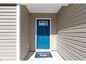 Bright blue front door with a window, and a 'Welcome' mat at the entrance at 2334 Black Rock Cir, Lebanon, IN 46052