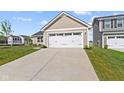 Attached two-car garage featuring a concrete driveway and manicured front lawn at 2334 Black Rock Cir, Lebanon, IN 46052