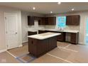 Spacious kitchen features dark wood cabinets, a center island, and ample countertop space at 2334 Black Rock Cir, Lebanon, IN 46052