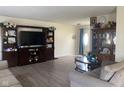 Cozy living room with hardwood floors, a lovely china cabinet and entertainment center at 2350 Harvest Moon Dr, Greenwood, IN 46143