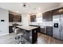 Modern kitchen with stainless steel appliances, dark cabinets, and a spacious island with barstool seating at 2628 Lamar Dr, Whitestown, IN 46075