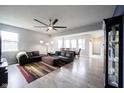 Spacious living room with stylish decor, a ceiling fan, and an open floor plan leading to the dining area at 2628 Lamar Dr, Whitestown, IN 46075
