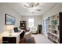 Bright office space featuring a modern desk, comfortable seating, and ample storage with built-in shelves and a ceiling fan at 2628 Lamar Dr, Whitestown, IN 46075