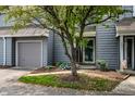 Charming townhome with grey wood siding, grey garage door, and inviting front yard landscaping at 2823 Somerset Bay, Indianapolis, IN 46240