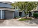 Charming townhome with grey wood siding, grey garage door, and inviting front yard landscaping at 2823 Somerset Bay, Indianapolis, IN 46240
