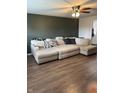 Spacious living room with a large comfortable sectional, ceiling fan, and laminate flooring at 2935 Flintwood Dr, Columbus, IN 47203