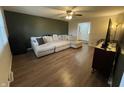 Inviting living room features a large sectional, ceiling fan, and wood-look floors at 2935 Flintwood Dr, Columbus, IN 47203